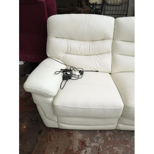 76 - A modern white leather electric reclining three seater sofa