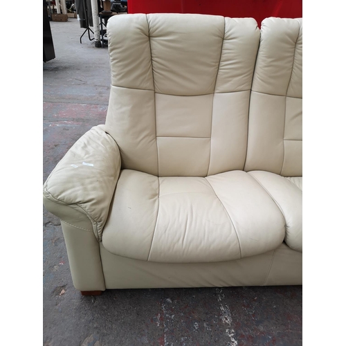 77 - An Ekornes Stressless cream leather reclining three seater sofa