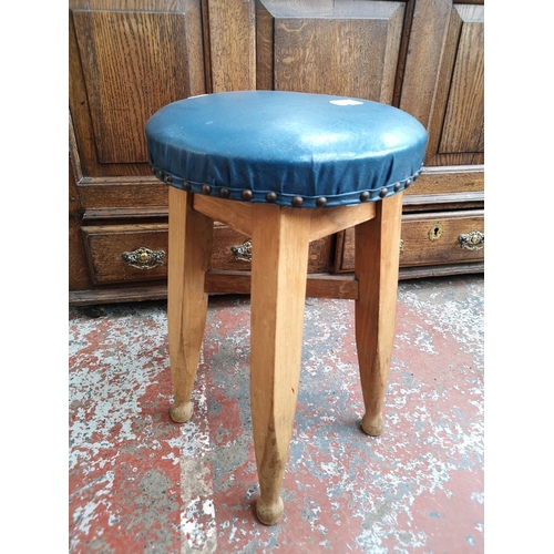 81 - An early/mid 20th century beech and blue vinyl stool - approx. 53cm high