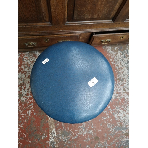 81 - An early/mid 20th century beech and blue vinyl stool - approx. 53cm high