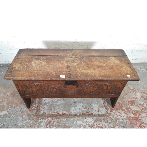 83 - A 17th century carved oak sword chest - approx. 52cm high x 100cm wide x 40cm deep