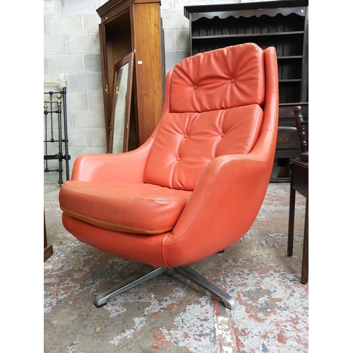 9 - A 1960s Swedish Dux orange vinyl and aluminium swivel lounge chair designed by Alf Svensson - ref no... 