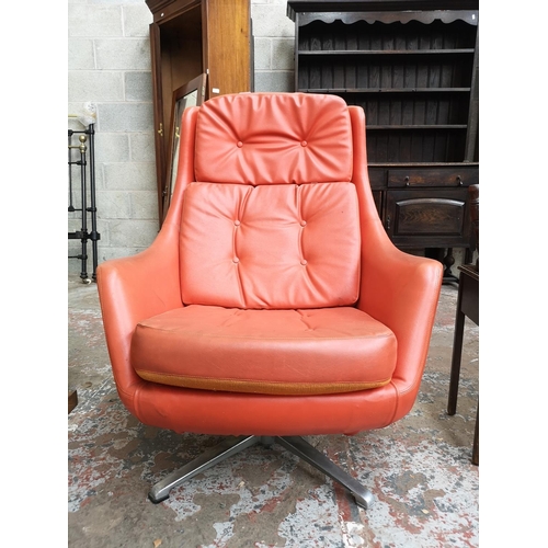 9 - A 1960s Swedish Dux orange vinyl and aluminium swivel lounge chair designed by Alf Svensson - ref no... 