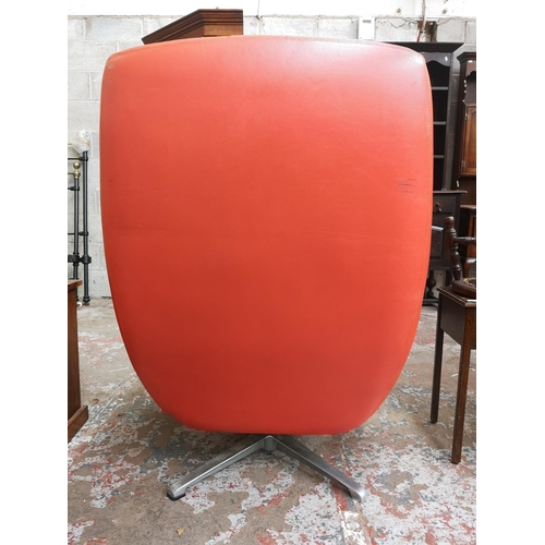 9 - A 1960s Swedish Dux orange vinyl and aluminium swivel lounge chair designed by Alf Svensson - ref no... 