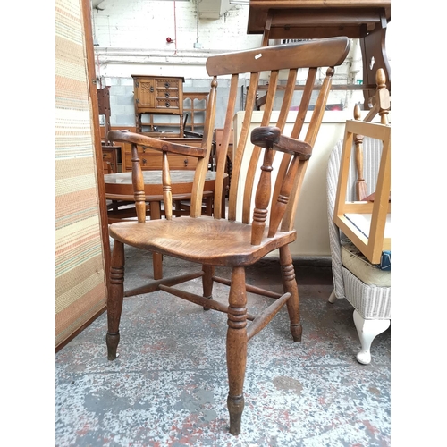 92 - A 19th century elm and beech grandfather chair, stamped W.R to rear - approx. 106cm high x 57cm wide... 