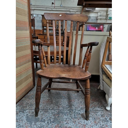 92 - A 19th century elm and beech grandfather chair, stamped W.R to rear - approx. 106cm high x 57cm wide... 