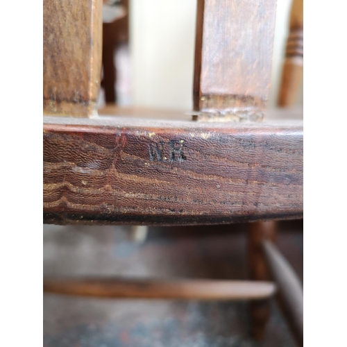 92 - A 19th century elm and beech grandfather chair, stamped W.R to rear - approx. 106cm high x 57cm wide... 