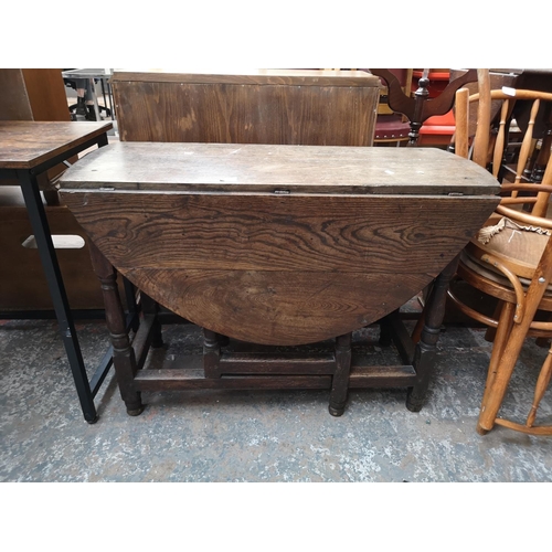 98 - A 19th century oak drop leaf gate leg oval dining table - approx. 72cm high x 103cm wide x 124cm lon... 