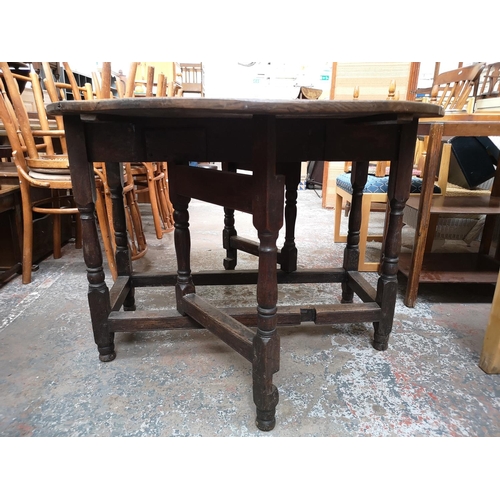 98 - A 19th century oak drop leaf gate leg oval dining table - approx. 72cm high x 103cm wide x 124cm lon... 