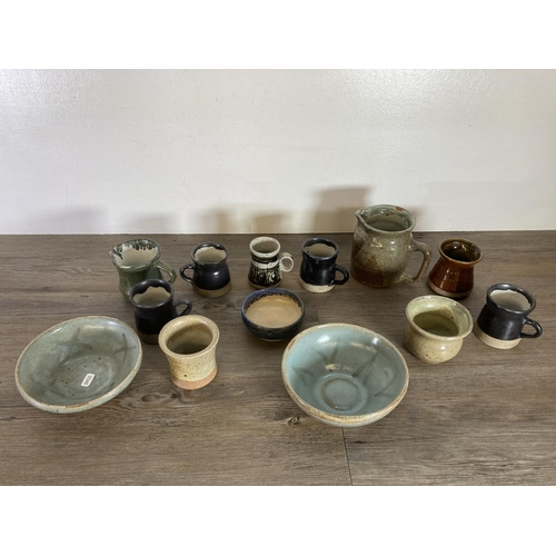 373 - A large collection of studio pottery to include Ayrton Looe blue drip glazed jug, mugs and bowl etc.