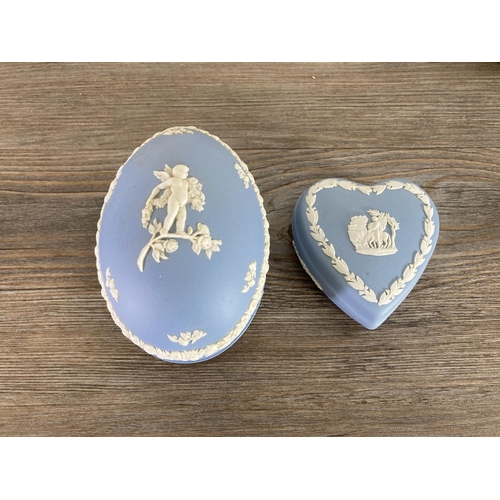 335 - A collection of Wedgwood pale blue Jasperware to include egg shaped trinket boxes, candlesticks, she... 