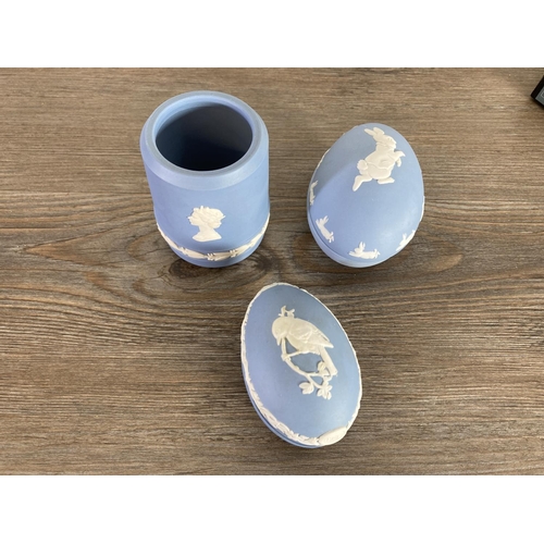 335 - A collection of Wedgwood pale blue Jasperware to include egg shaped trinket boxes, candlesticks, she... 