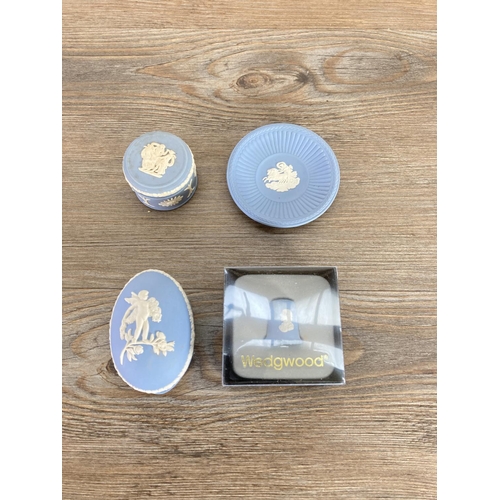 335 - A collection of Wedgwood pale blue Jasperware to include egg shaped trinket boxes, candlesticks, she... 