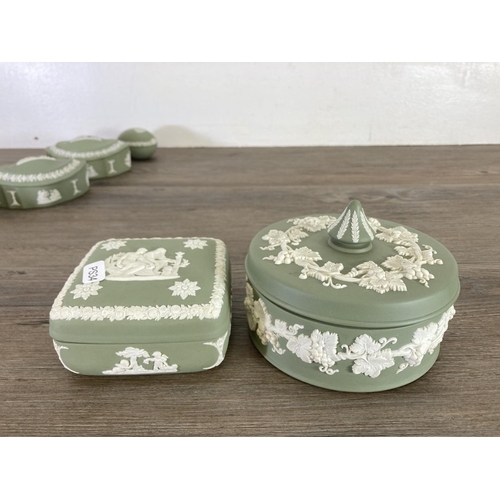 344 - Twelve Wedgwood sage green Jasperware trinket boxes and dishes