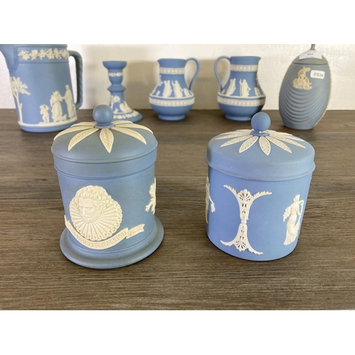 353 - Seven pieces of Wedgwood pale blue Jasperware to include two Etruscan jugs, candlestick etc.