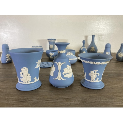 355 - A collection of Wedgwood pale blue Jasperware to include bud vases, salt and pepper shakers etc.