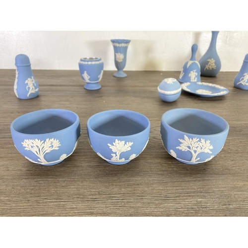 355 - A collection of Wedgwood pale blue Jasperware to include bud vases, salt and pepper shakers etc.