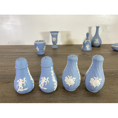 355 - A collection of Wedgwood pale blue Jasperware to include bud vases, salt and pepper shakers etc.