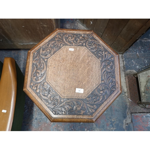 132 - An early 20th century carved oak octagonal two tier side table