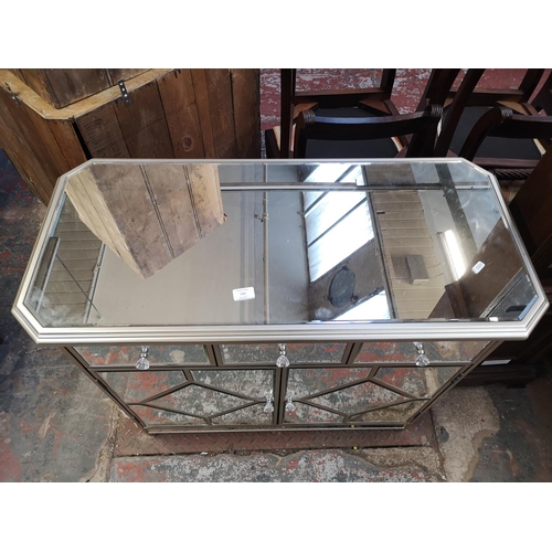 133 - A modern mirrored glass sideboard with three drawers and two cupboard doors - approx. 87cm high x 97... 