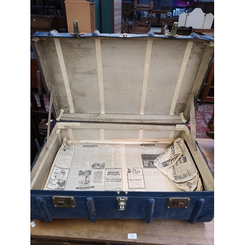 135 - An early 20th century blue painted travel trunk