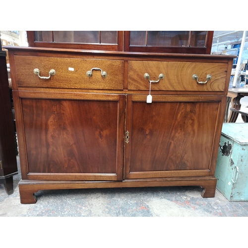 144 - A Georgian style mahogany bookcase with two upper astral glazed doors, two drawers and two lower cup... 