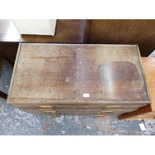 154 - A mid 20th century walnut chest of four drawers