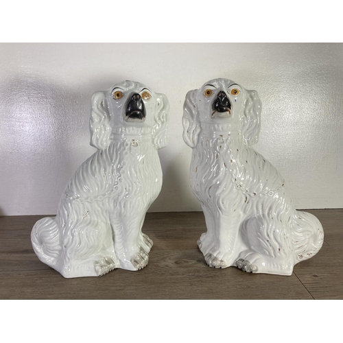 390 - Three items, two Staffordshire flatback spaniel figurines - approx. 35cm high and one Sarreguemines ... 