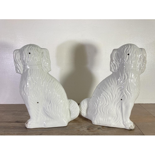 390 - Three items, two Staffordshire flatback spaniel figurines - approx. 35cm high and one Sarreguemines ... 