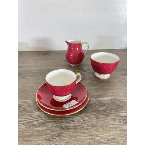 415 - A collection of Wedgwood pattern W4206 powder ruby red bone china to include seven tea cups, six sau... 