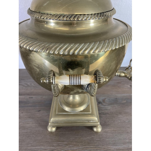 428 - A Victorian brass samovar - approx. 44cm high and brass three piece companion set