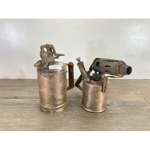 434 - A collection of brassware to include Burmos British Monitor made No.26 blowtorch, two trench art vas... 