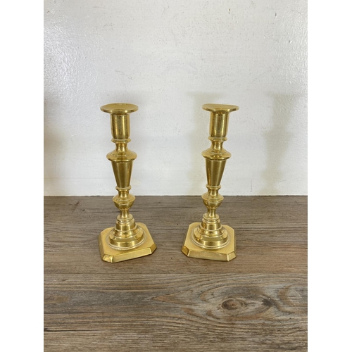 439 - Three pairs of brass candlesticks - largest approx. 24cm high