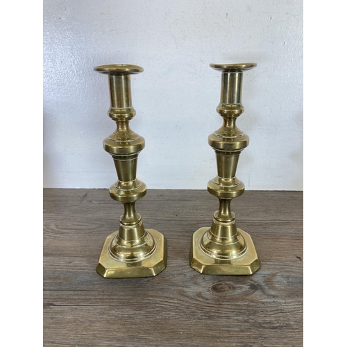 439 - Three pairs of brass candlesticks - largest approx. 24cm high