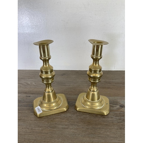 439 - Three pairs of brass candlesticks - largest approx. 24cm high