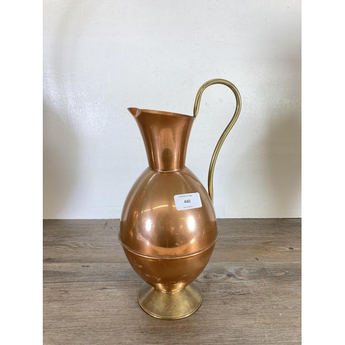 440 - Three copper and brass jugs - largest approx. 49cm high