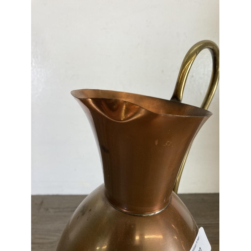 440 - Three copper and brass jugs - largest approx. 49cm high