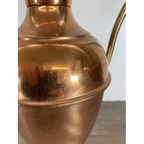 440 - Three copper and brass jugs - largest approx. 49cm high