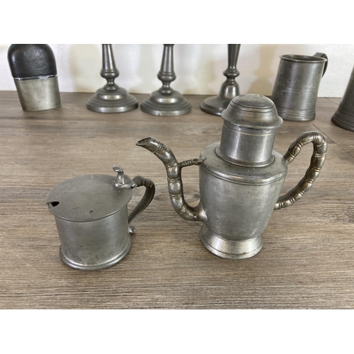 445 - A collection of pewter to include Tudric handled plate, candlesticks, tankards etc.