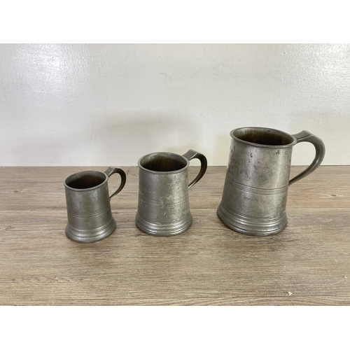 445 - A collection of pewter to include Tudric handled plate, candlesticks, tankards etc.