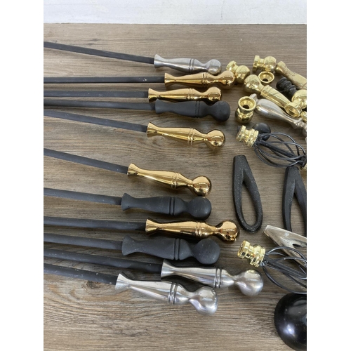 450 - A collection of wrought iron fire pokers and various handles