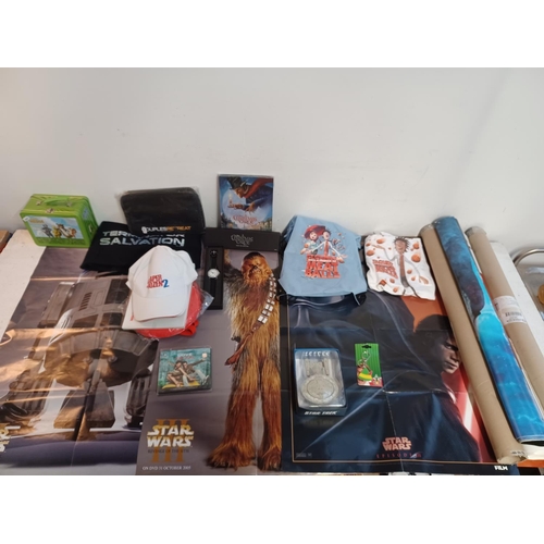 863 - A collection of film posters and merchandise to include four Star Wars two sided posters, Terminator... 