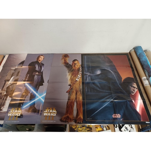 863 - A collection of film posters and merchandise to include four Star Wars two sided posters, Terminator... 