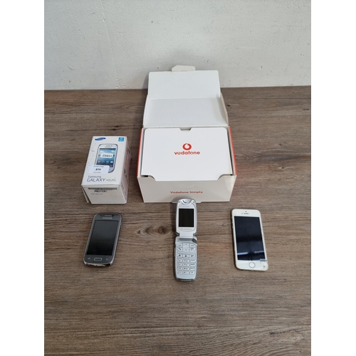 879 - Three mobile phones, one boxed Vodafone Segem VS3 flip, one boxed Samsung Galaxy Young and one Apple... 