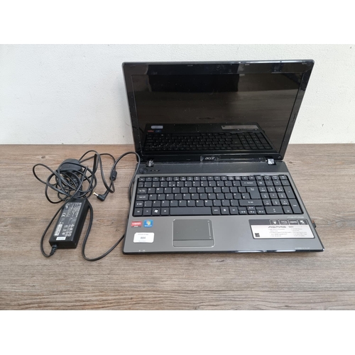 884 - An Acer Aspire 5551 Windows 7 Home Premium laptop with power adapter