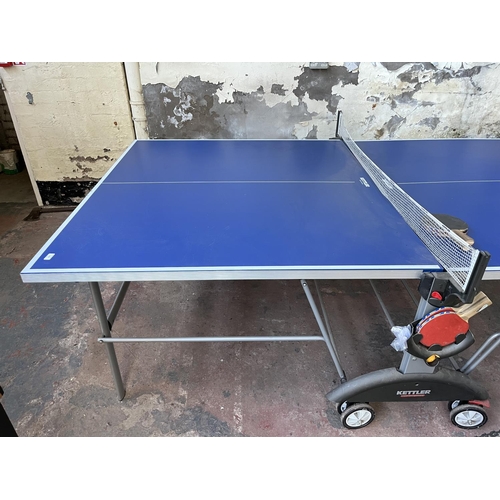 201 - A Kettler Topstar folding table tennis table with four paddles - approx. 76cm high x 275cm long x 15... 