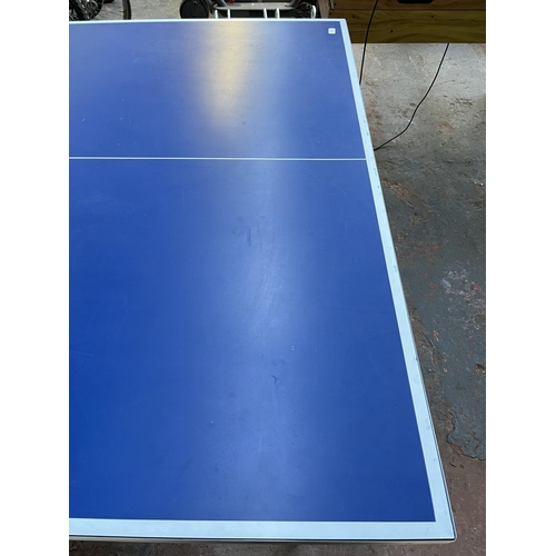 201 - A Kettler Topstar folding table tennis table with four paddles - approx. 76cm high x 275cm long x 15... 