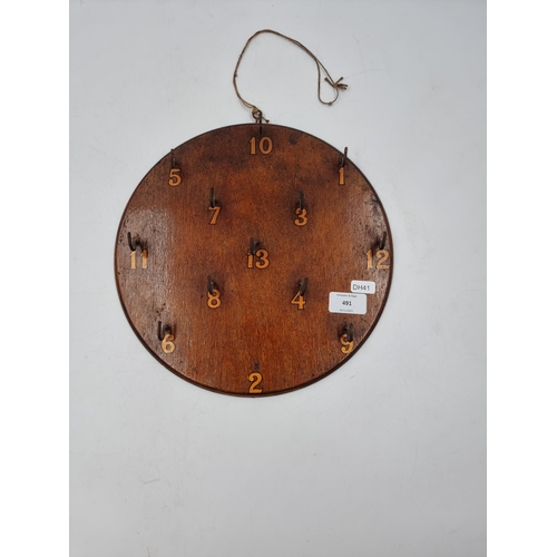 491 - An oak Hoopla board - approx. 30cm diameter