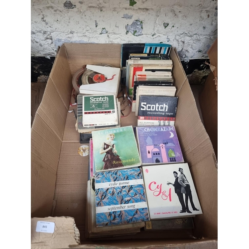 845 - A box containing a collection of reel-to-reel tapes to include original titles