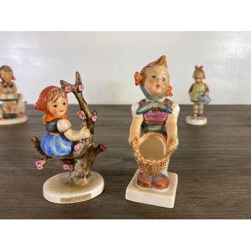 417 - Twelve items, six West German Goebel Hummel figurines and six Royal Doulton miniature character jugs